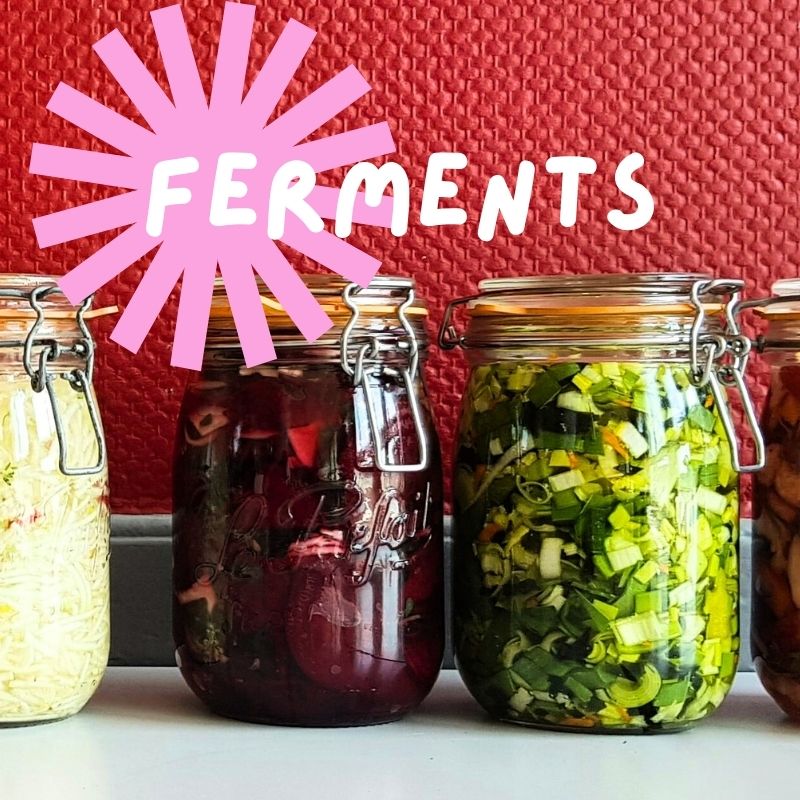 Jars of fermenting vegetables on a counter