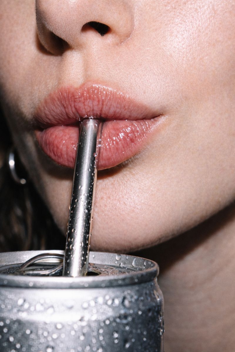 Flash-lit drink moment with condensation and glassware